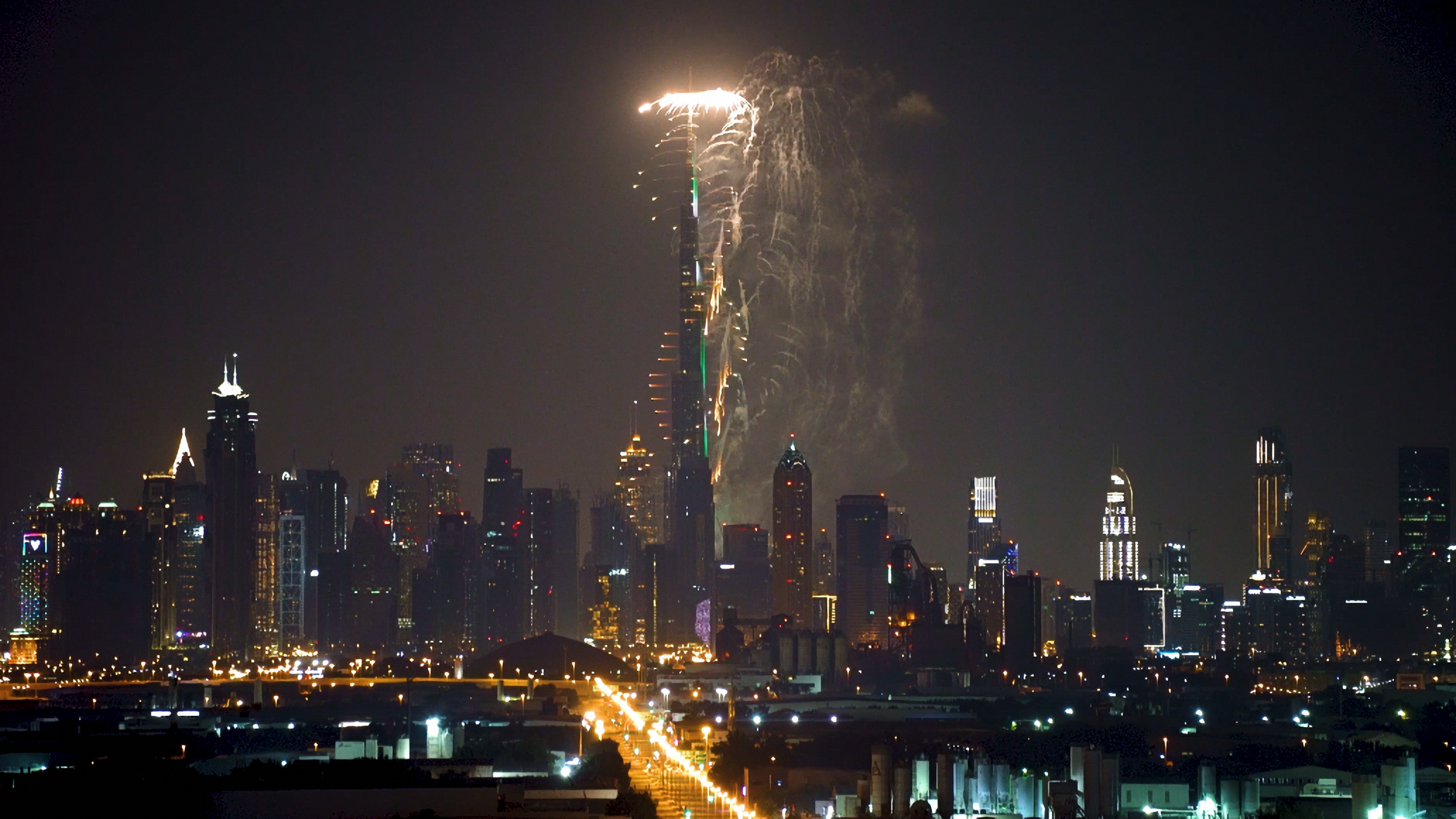 Fireworks exploding over the Dubai skyline and Burj Khalifa on New Year's Eve